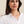 Woman wearing a white shirt against a plain background