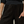 Person wearing black pants with cargo pockets against a neutral background