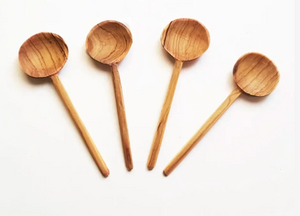 Four wooden spoons on a white background