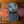 Four round containers with colorful lids on a woven surface