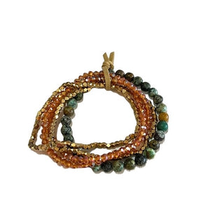 Set of beaded bracelets with orange, green, and gold colors on a white background