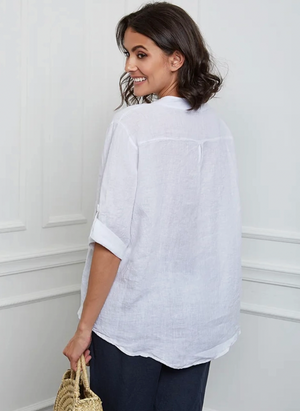 Woman wearing a white henley shirt against a white background