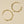 Gold hoop earrings on a beige background