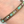 Beaded bracelet with multicolored beads on a wrist against a neutral background