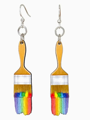 Earrings shaped like paint brushes with rainbow bristles on a white background