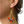 Close-up of an ear wearing a colorful beaded earring.