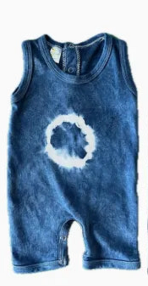 Blue sleeveless romper with a white circular tie-dye design on a white background