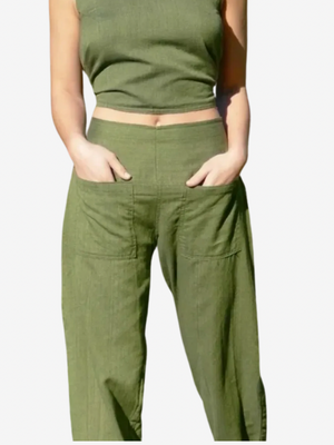 Person wearing green pants and a cropped top on a white background