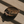Wooden eye-shaped dish with gold earrings on a wooden surface