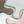 Close-up of multicolor glass tile with a wavy edge on a white background