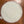 Bottom view of round woven mat on a wooden floor