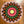 Colorful crocheted mandala on a wooden surface