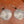 Silver earrings with leaf patterns on a wooden surface