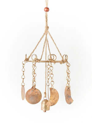 Decorative hanging mobile with gold and bronze elements on a white background