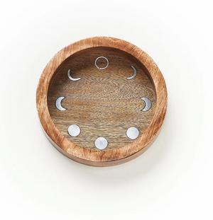 Wooden tray with moon phase cutouts on a white background