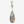 Teardrop-shaped pendant with floral pattern on a white background