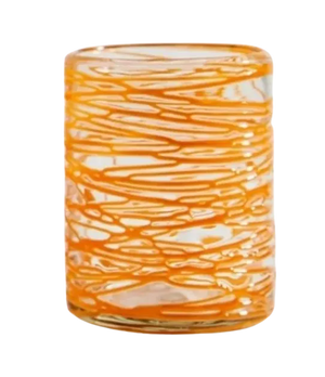 Glass with orange and white marbled pattern on a white background