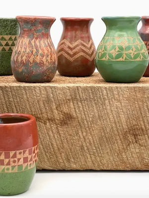 Set of ceramic vases with geometric patterns on a wooden block