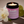 Kandu candle with orchid and bergamot scents, surrounded by flowers and limes on a neutral background