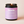 Kandu candle with a purple label on a beige background