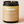 Kandu Palo Santo Tobacco candle with a beige label on a light pink background