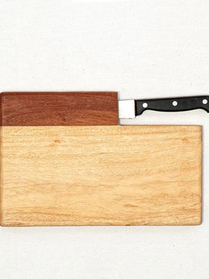 Wooden cutting board with a knife on a white background