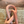 Pink ceramic sculpture on a wooden surface