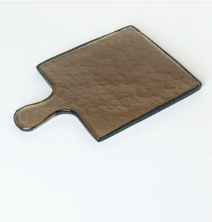 Textured brown glass cutting board on a white background