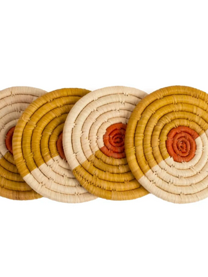 Set of four multicolor round woven coasters with concentric circle pattern on a white background