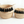 Two woven baskets with black tassels on a white background