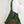 Person wearing a green macrame bag on a plain background