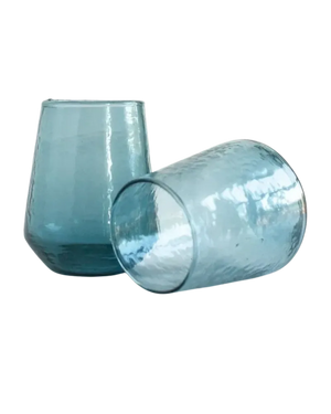 Two blue glass tumblers on a white background