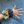 Hand wearing a colorful scrunchie with a striped fabric background