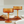 Two amber-colored cocktail glasses on a table with a blurred background