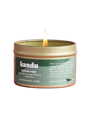 Kandu candle with a lit wick on a white background