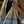 Person holding a striped towel with a blurred natural background