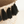 Black tassels hanging from a straw basket