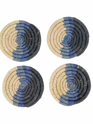 Four round woven coasters with blue and beige pattern on a white background