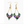 Pair of beaded earrings with green, purple, and gold colors on a white background