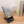 Phone stand with sun design on a wooden surface with books in the background