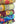 Stack of colorful kantha quilts with various patterns on a white background