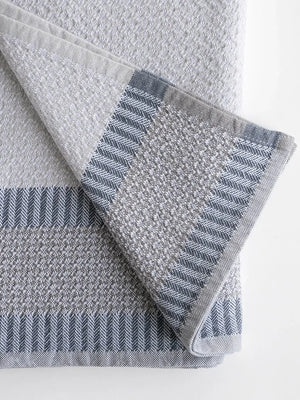 Gray and blue patterned hand towel on a white background
