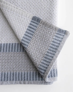 Gray and blue patterned hand towel on a white background