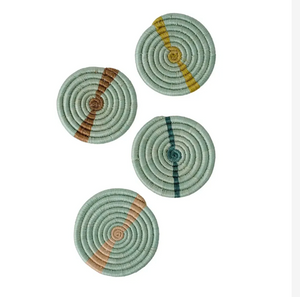 Set of four multicolor woven coasters with spiral pattern on a white background