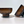 Two brown glasses on a white surface with a light gray background