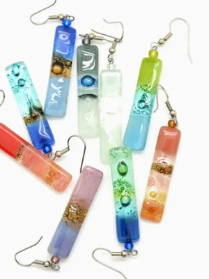 Colorful glass tube earrings on a white background