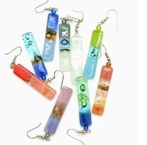 Colorful glass tube earrings on a white background