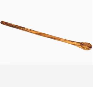 Long natural wood stirring spoon on white background